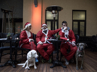 Runners dressed as Santa Claus take part in the 3rd edition of the 'Athens Santa Claus Run' in central Athens, on December 4, 2016. (