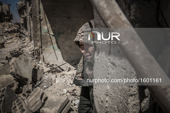 A woman crying in her house, destroyed after an airstrike in the eastern Ghouta of Damascus, Syria, on April 4, 2016.  