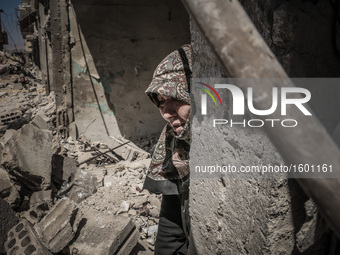 A woman crying in her house, destroyed after an airstrike in the eastern Ghouta of Damascus, Syria, on April 4, 2016.  (