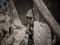 A woman crying in her house, destroyed after an airstrike in the eastern Ghouta of Damascus, Syria, on April 4, 2016.  (