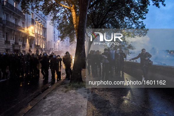 Protesters clash with anti-riot police during a demonstration against the use of the French constitution's Article 49,3, allowing the govern...