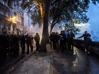 Protesters clash with anti-riot police during a demonstration against the use of the French constitution's Article 49,3, allowing the govern...