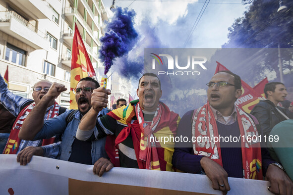 Thousands of people shout slogans and wave flags as they take to the streets to protest Prime Minister Matteo Renzi's government politics an...