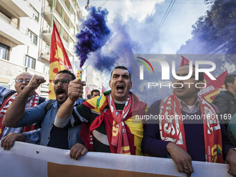 Thousands of people shout slogans and wave flags as they take to the streets to protest Prime Minister Matteo Renzi's government politics an...