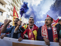 Thousands of people shout slogans and wave flags as they take to the streets to protest Prime Minister Matteo Renzi's government politics an...