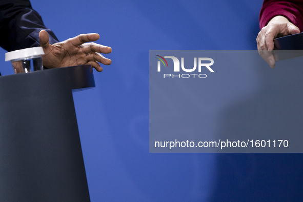 The hands of US President Barack Obama and German Chancellor Angela Merkel are pictured during a news conference at the Chancellery in Berli...