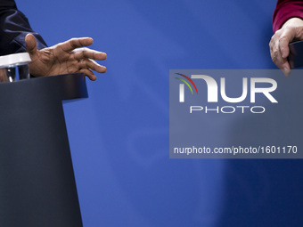 The hands of US President Barack Obama and German Chancellor Angela Merkel are pictured during a news conference at the Chancellery in Berli...