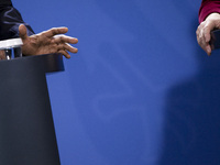 The hands of US President Barack Obama and German Chancellor Angela Merkel are pictured during a news conference at the Chancellery in Berli...