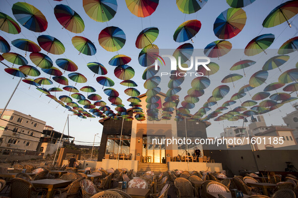 Palestinians Muslims decorate the streets with colourful umbrellas as they celebrate the Muslim holy month of Ramadan in Gaza City on 9 June...