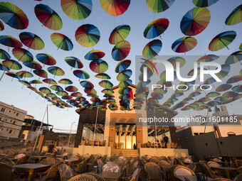 Palestinians Muslims decorate the streets with colourful umbrellas as they celebrate the Muslim holy month of Ramadan in Gaza City on 9 June...