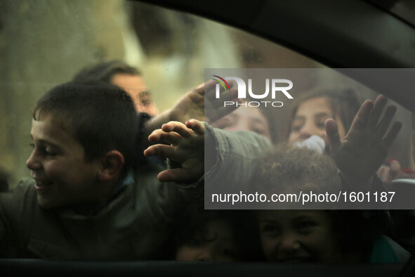 Palestinian children play in a poverty-stricken quarter on a rainy day of Beit Lahia town, in the northern Gaza Strip, on January 25, 2016. 