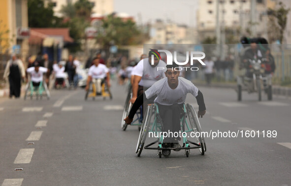 Palestinian men on their wheelchairs compete in a marathon organised for Palestinians who have been wounded by wars, on November 29, 2016 in...