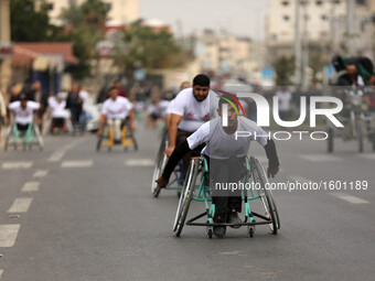 Palestinian men on their wheelchairs compete in a marathon organised for Palestinians who have been wounded by wars, on November 29, 2016 in...