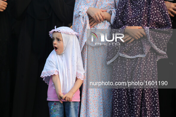 Palestinians attend the morning prayers for Eid al-Fitr celebrations, which marks the end of the holy fasting month of Ramadan, in Gaza City...