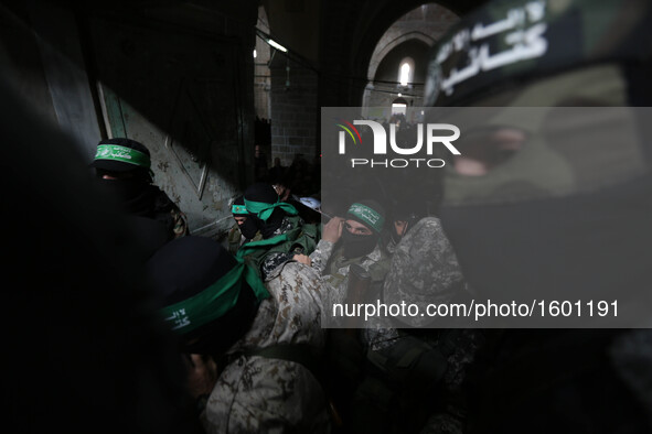 Mourners carry the bodies of one of the seven Palestinian Hamas gunmen who were killed when a tunnel collapsed close to the Gaza Strip's eas...