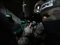 Mourners carry the bodies of one of the seven Palestinian Hamas gunmen who were killed when a tunnel collapsed close to the Gaza Strip's eas...