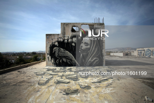 Graffiti made by street artist WD of a woman holding a bird, Athens, Greece, October 26, 2016 