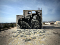 Graffiti made by street artist WD of a woman holding a bird, Athens, Greece, October 26, 2016 (