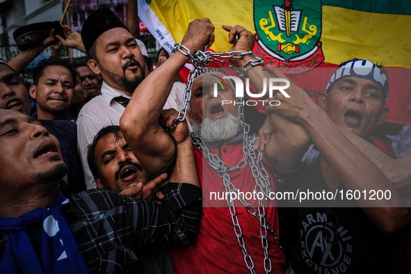 A Rohingya Muslim in Malaysia chain himself during  'Stop the Oppression of  Rohingya' assembly outside Myanmar Embassy in Kuala Lumpur on N...