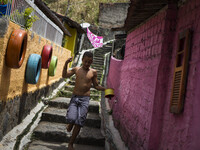 A boy is seen playing with a kite. Project to leave the visually pleasing favelas is put into practice in the community of Corrego do Jenipa...