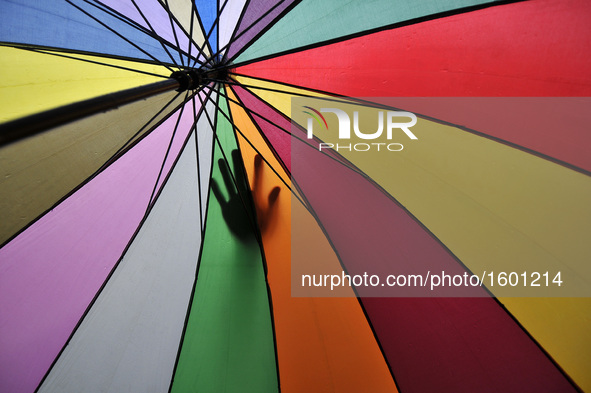 A hand of Nepalese Muslim seen on his friend's umbrella as came to offer Ritual Prayer on Last Friday of Ramadan on a monsoon rain at Kashma...