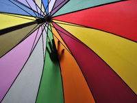 A hand of Nepalese Muslim seen on his friend's umbrella as came to offer Ritual Prayer on Last Friday of Ramadan on a monsoon rain at Kashma...