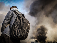 Fire takes hold in the notorious Jungle camp as migrants leave and the authorities demolish the site on October 26, 2016 in Calais, France....