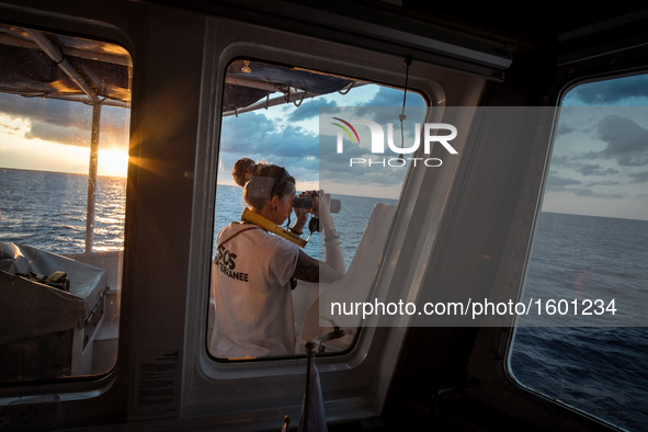  At sunrise, on Sep 9th 2016 the SOS Méditerranée Deputy Search And Rescue Coordinator scan the horizon with a binocular in search for migra...