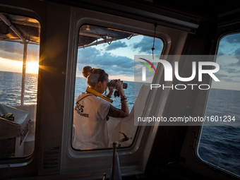  At sunrise, on Sep 9th 2016 the SOS Méditerranée Deputy Search And Rescue Coordinator scan the horizon with a binocular in search for migra...