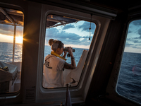  At sunrise, on Sep 9th 2016 the SOS Méditerranée Deputy Search And Rescue Coordinator scan the horizon with a binocular in search for migra...