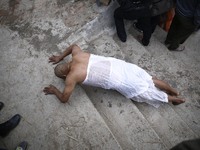 A Nepalese Hindu devotee rolls on the ground as a part of ritual after taking holy bath in the Shali River on the first day of Madhav Naraya...