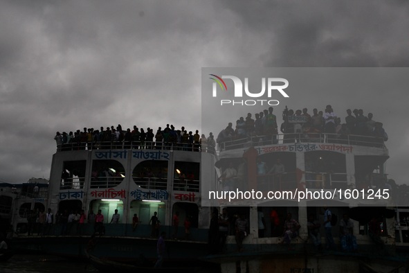 People watches the immersion of hindu goddesses from a ferry rooftop on the last day of Durga Puja at the bank of river Buriganga, Dhaka, Ba...