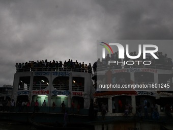 People watches the immersion of hindu goddesses from a ferry rooftop on the last day of Durga Puja at the bank of river Buriganga, Dhaka, Ba...