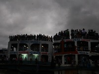 People watches the immersion of hindu goddesses from a ferry rooftop on the last day of Durga Puja at the bank of river Buriganga, Dhaka, Ba...