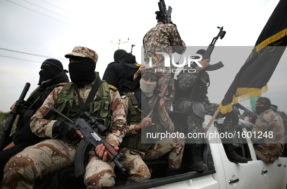 Palestinian militants from al-Quds Brigades the armed wing of the Islamic Jihad organization attend the funeral of seven Hamas gunmen who we...