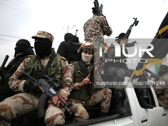 Palestinian militants from al-Quds Brigades the armed wing of the Islamic Jihad organization attend the funeral of seven Hamas gunmen who we...