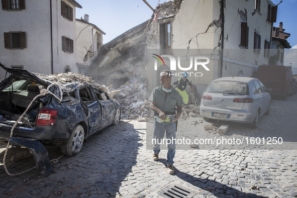 Rescuers search for victims in damaged buildings after a strong earthquake hit Amatrice on August 24, 2016. Central Italy was struck by a po...