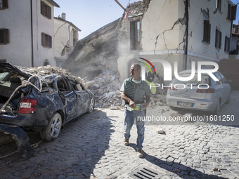 Rescuers search for victims in damaged buildings after a strong earthquake hit Amatrice on August 24, 2016. Central Italy was struck by a po...