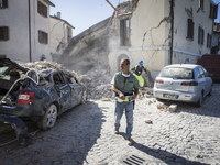 Rescuers search for victims in damaged buildings after a strong earthquake hit Amatrice on August 24, 2016. Central Italy was struck by a po...