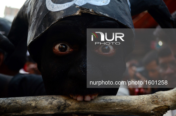 An indian artist,dressed as an evil character,performs with human skull and bones ,during Maha ShivaRatri festival,celebrated in reverence o...