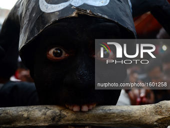 An indian artist,dressed as an evil character,performs with human skull and bones ,during Maha ShivaRatri festival,celebrated in reverence o...