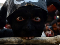 An indian artist,dressed as an evil character,performs with human skull and bones ,during Maha ShivaRatri festival,celebrated in reverence o...