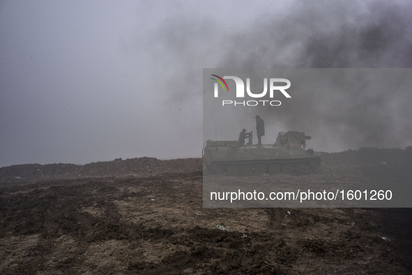 Syrian People's Protection Units (YPG) members in a tank in frontline of Raqqa, on January 7, 2016 fight against the Daesh. 