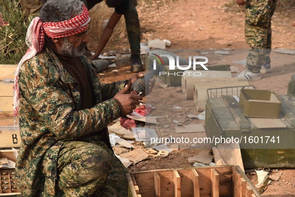 A soldier of pro-government militia prepares ammunition in Aleppo, Syria, on Dec. 11, 2016. The Syrian army and allied fighters are now in c...