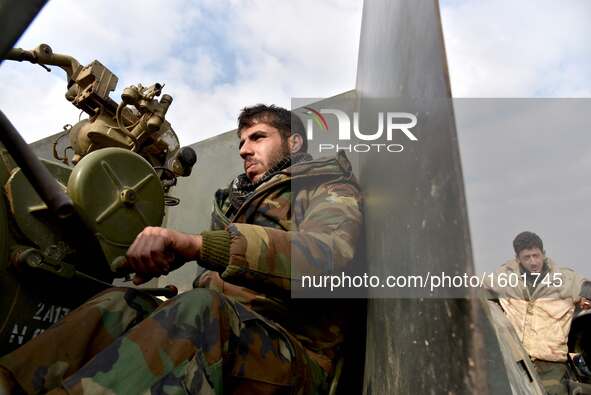 A soldier of pro-government militia prepares to fire to rebel-held areas in Aleppo, Syria, on Dec. 11, 2016. The Syrian army and allied figh...