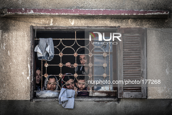 Palestinians seen from the window of the house before an Israeli air raid on a nearby house. Israeli air strikes on the Gaza Strip, killing...