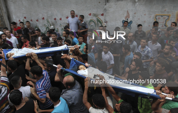 Relatives carry the bodies of two children from Shuhaiber family Jihad Issam Shuhaiber and Waseem Issam Shuhaiber during their funeral in Ga...