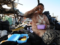 Nurtinah eats during her time work break.
Nurtinah, 47, a farm worker from Pucang Anom village, Cerme sub-district, Bondowoso district, East...