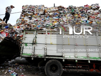 A worker puts the garbage into a truck.
Surabaya Municipality Government has developed an effective community education program about waste...