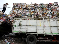 A worker puts the garbage into a truck.
Surabaya Municipality Government has developed an effective community education program about waste...